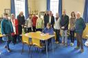 Rev Hermione Morris signing contract supported by Friends of St Myllin's Church.