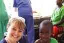 Yvonne holds a Tanzanian baby alongside sister. Love holding the babies!