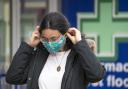 A shopper wears a protective face mask in Edinburgh's Princes Street. PA Photo. Picture date: Thursday July 2, 2020. It was announced today that face coverings will be mandatory in shops in Scotland from July 10. See PA story HEALTH Coronavirus.