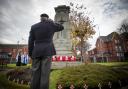 A former serviceman salutes at the war memorial after laying a wreath during the Newtown Remembrance Sunday parade.