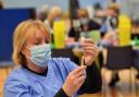 Health care workers give out injections at Cwmbran Stadium, south Wales. Picture date: Tuesday January 26, 2021.