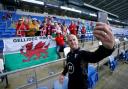 Wales manager Robert Page takes a selfie with some fans before the UEFA Nations League match at the Cardiff City Stadium, Cardiff. Picture date: Wednesday June 8, 2022.