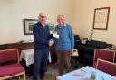 A cheque for £100 is presented to Reg Cawthorne, chairman of the Bracken Trust, by Pentref member Clive Barrett. 