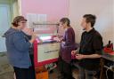 Machspace volunteers Nikki, Fee and Avery with the new laser cutter.