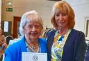 Olive Williams presented with a certificate for 50 years of service by Inner Wheel District 18 chairman Muriel McGrath.
