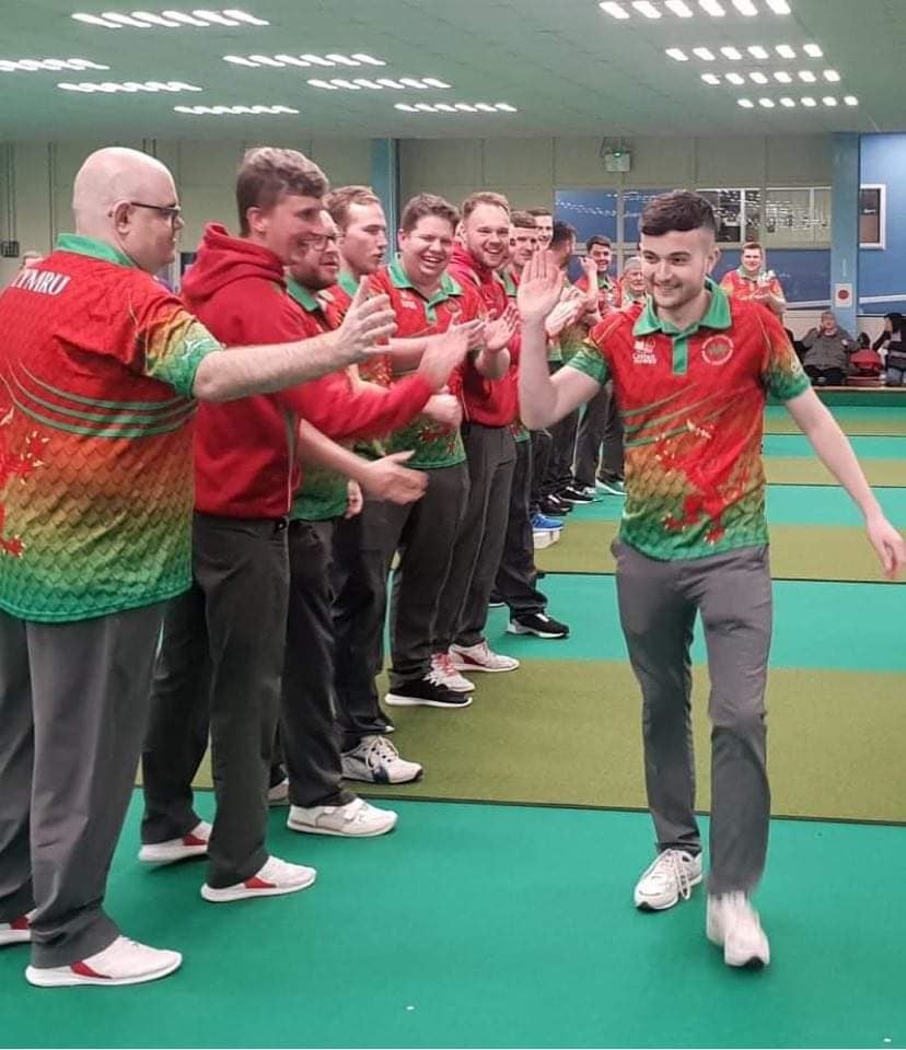 Jac Edwards high-fives his Welsh team mates after winning the short mat bowls singles at the British Isles Championships in Scarborough. Picture by BowlsWales
