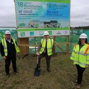 Powys County Council's then Cabinet Member for Housing, Cllr Iain McIntosh (centre) cuts the turf in August 2021 to mark the start of work on affordable properties on the former Red Dragon site in Newtown.