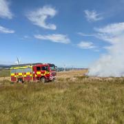 Llanfair firefighters dealing with the grass fire near Adfa