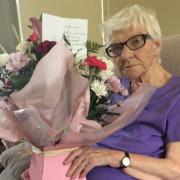 Enid Jones, with the boquet she recieved for 62 years of poppy collecting