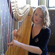 Harpist Alis Huws performs during a reception attended by King Charles III and the Queen Consort at Cardiff Castle in Wales.