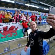 Wales manager Robert Page takes a selfie with some fans before the UEFA Nations League match at the Cardiff City Stadium, Cardiff. Picture date: Wednesday June 8, 2022.