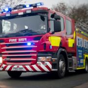 Fire crews were called to a Powys border village after a shed fire got out of control.