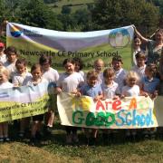 Children and staff at Newcastle CofE Primary School celebrating the good Ofsted report in 2023