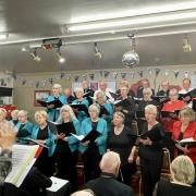 The combined choirs of Cor Llanwnog and The Wesley Singers under the baton of Stella Gratrix