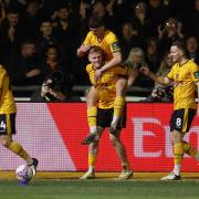 Will Evans of Newport County celebrates with teammates after scoring a goal against Man Utd in their FA Cup match.