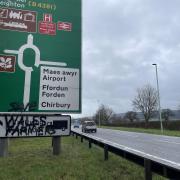 Would-be artists have spray painted the slogan ‘Save Wales Farmers’ on a sign alongside the A483 approach into Welshpool.
