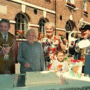 The mayor of Montgomery and his wife Joan, celebrating the Queen mom's 100th on the street of montgomery. Pictured with Jess Sleigh(cutting cake), the town crier, Bill Orme, and The mayor's grandson Matthew Musharafeih,6, from Lebanon, Beirut.