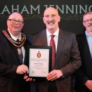 Graham Jennings receiving his Honorary Freeman Award by Mayor of Newtown & Llanllwchaiarn Cllr John Byrne and Chair for the Environment and Economy Cllr Richard Edwards.