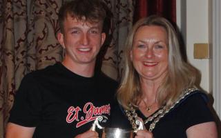 Llandrindod mayor Marcia Morgan presents Ryan Rowlands with the best clubman overall trophy