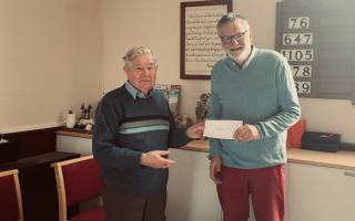 John Lloyd presents donations to Martin Sweet, of Parkinson’s UK's south Powys branch.