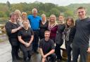 BBC weatherman Derek Brockway (back, 4th l) and Llandrindod's own Sue Charles (2nd r) pictured with staff T Lakeside Café.