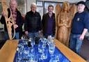Pictured is some of the glassware on display with  co-ordinator Bryan Jones (2nd from left), and members of Builth Wells Rotary Club who helped with staging the exhibition. Two wooden carvings, including the 6 feet tall figure are also shown on the