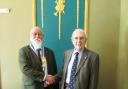 The new chairman, Steve Sims (left), congratulates Dr Sim Ovis on his new appointment as club president.