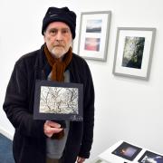The photo shows Jeff Dixon, who helped co-ordinate the exhibition, with a selection of signed images on show, all taken by his friend, the late Steve Harris. Ted Edwards Photography.