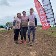 Eleanor Langford, Lowri Griffiths, and Natasha Rowe  after completing their 5k mud run.
