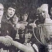 Newtown Football Club captain Keith Tanner lifts the Central Wales Cup in 1975.