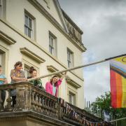 Organisers of Machynlleth Pride raising the flag at Y Plas to mark the event.