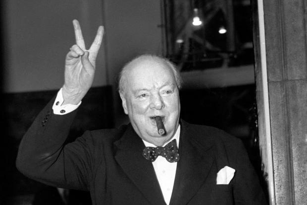Sir Winston Churchill giving his familiar 'V' sign.