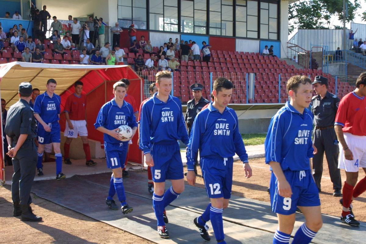 Hugh Clarke and his Caersws team-mates walk out in Dupnitsa.