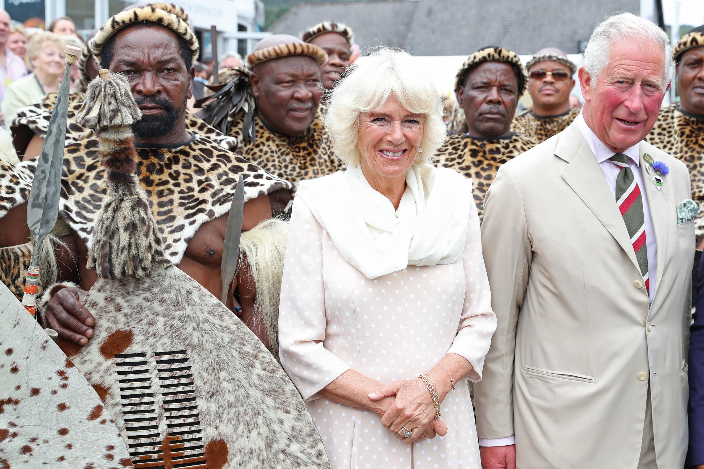 The Prince of Wales and Duchess of Cornwall meet members of the Zulu impi regiment during the 100th Royal Welsh Show at the Royal Welsh Showground, Llanelwedd, Builth Wells. PRESS ASSOCIATION Photo. Picture date: Monday July 22, 2019. See PA story ROY