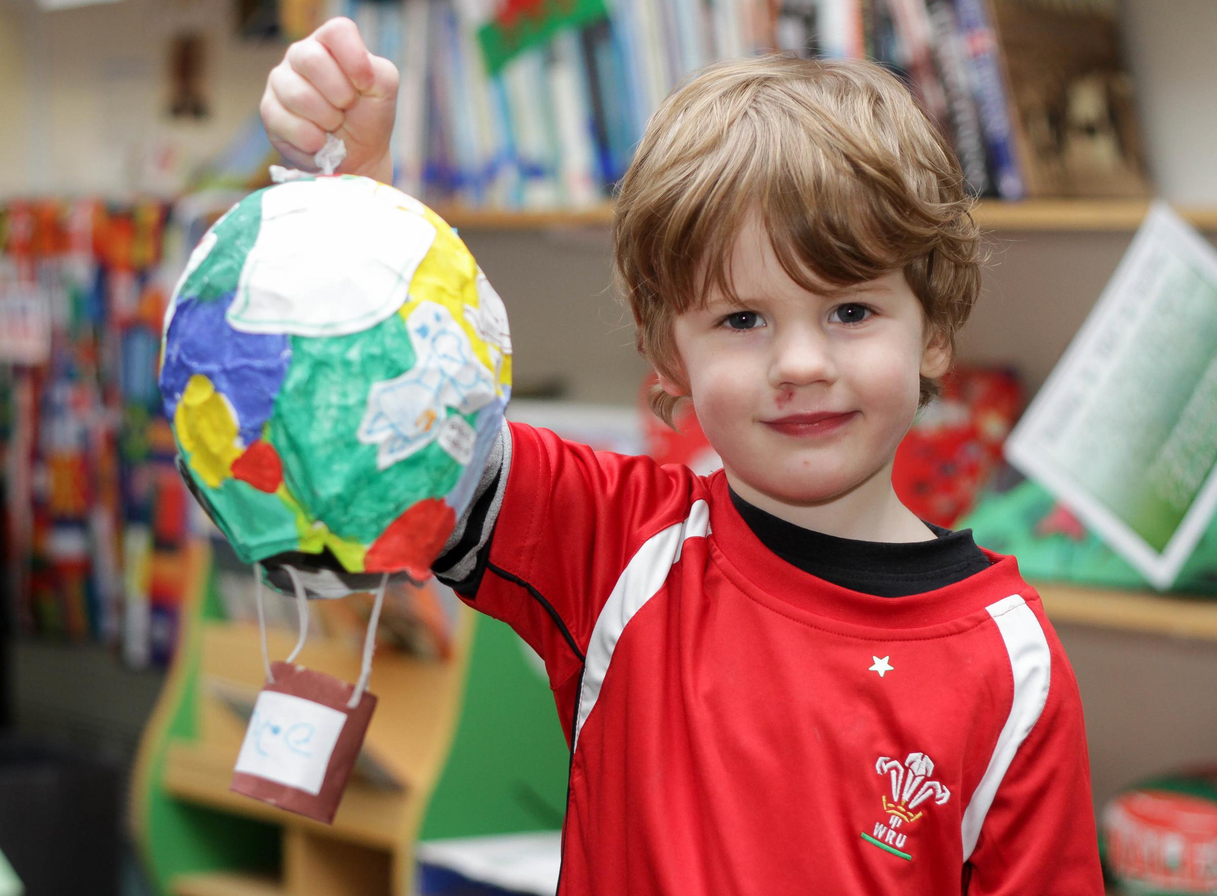 Pupils from Treowen Primary School celebrated St Davids Day before the Half term and held their school Eisteddfod. Pic is. First prize winner of the 3D Art and Crafts with his hot air balloon is four-year-old, Vincent Evans. RD069_2014-7