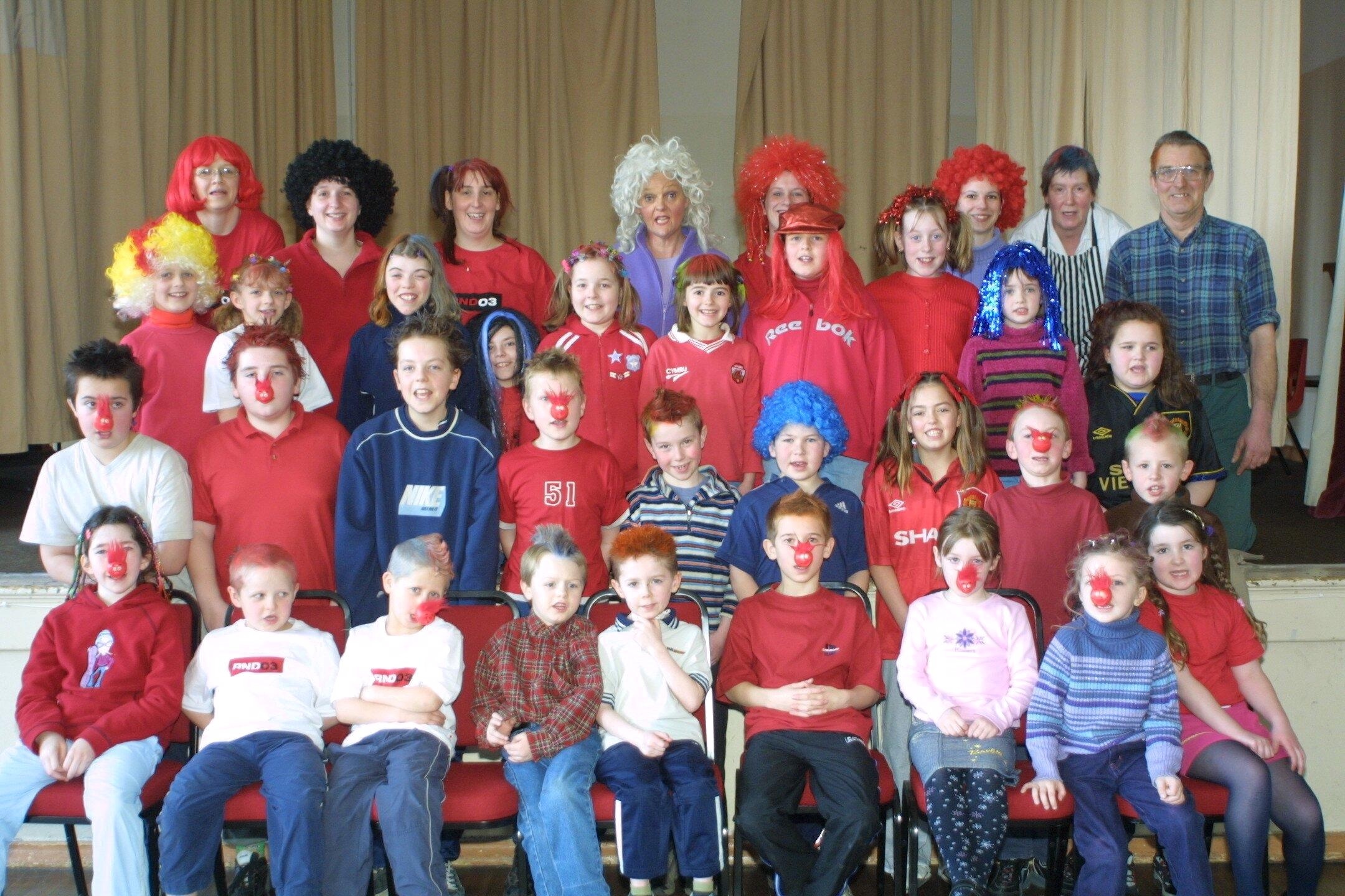 Llanwddyn Primary School children raised over £250 for Red Nose day from dressing up in red for the day pic are staff and children from the school.