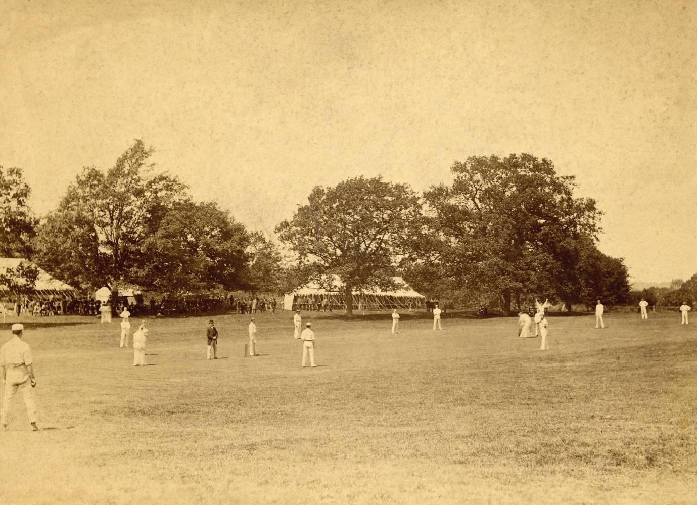 A photograph showing the Twenty-Two of Montgomery in the field with the refreshment tents and a small stand in the background.