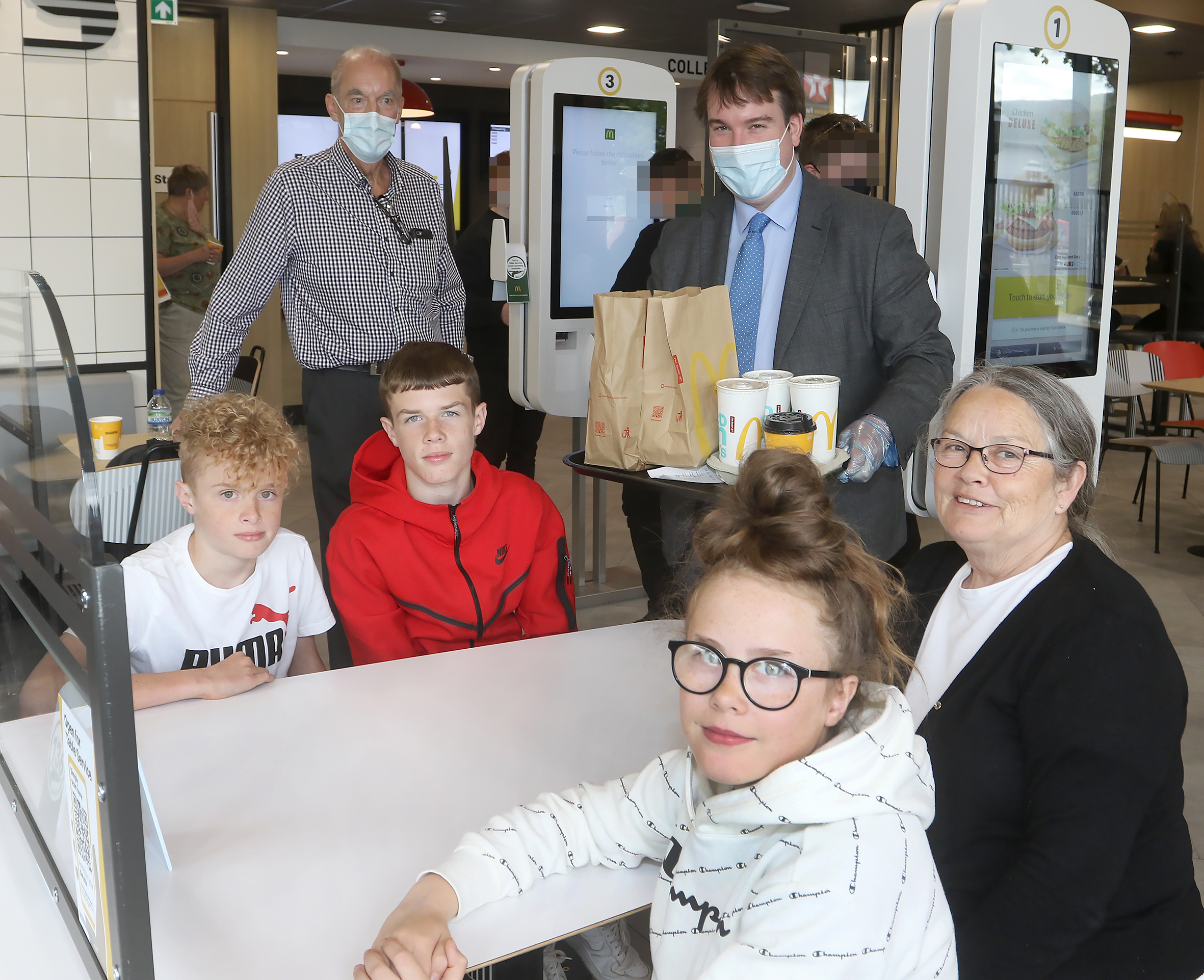 Official opening of the new McDonalds in Welshpool by Montgomeryshire MP Craig Williams and Franchisee Bob Beckett. Pictured is Craig Williams serving the 1st customers, Kathleen Comaskey and her step-grandchildren, Jacob, Rian and Liv from