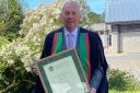 Tom Jones OBE, from Dolanog, with his honorary fellowship from Aberystwyth University in July 2022.