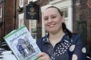 General Manager of the Royal Oak, Laura Hindle, with a copy of the book