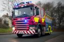 Fire crews were called to a Powys border village after a shed fire got out of control.
