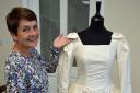 Former seamstress Sharon Wells with the wedding dress she helped make in 1992.