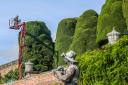 Gardeners begin the long process of cutting the hedges at Powis Castle.