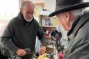 Machynlleth Repair Cafe fixer Ian Gregory mending a lamp brought in by Phil Wheeler.