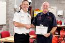Steve Amor (r) receiving his long-service award from assistant chief fire officer Craig Flannery.