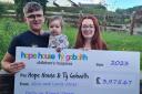 Alice and Lewis and their daughter Mina with their fundraising cheque for Hope House