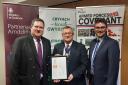 Craig Middle (l), of the Reserve Forces and Cadets Wales, presents the Defence ERS bronze award to Cllr William Powell, assistant vice chair of PCC, and Cllr Matthew Dorrance.