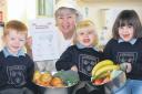 : Gungrog Nursery and Infants School has been awarded the Welsh Food Hygiene Award Silver Standard. From left are Lewis Owen, four, cook in charge Sheila Evans, Molly Ryder, four, and Jasmin Hawkes, five.
