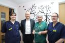 Tracey Spooner (second from right) is pictured receiving her award from Dr Carl Cooper (second from left) watched by Sisters Sarah Williams (right) and Vicky Jones.