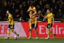 Will Evans of Newport County celebrates with teammates after scoring a goal against Man Utd in their FA Cup match.